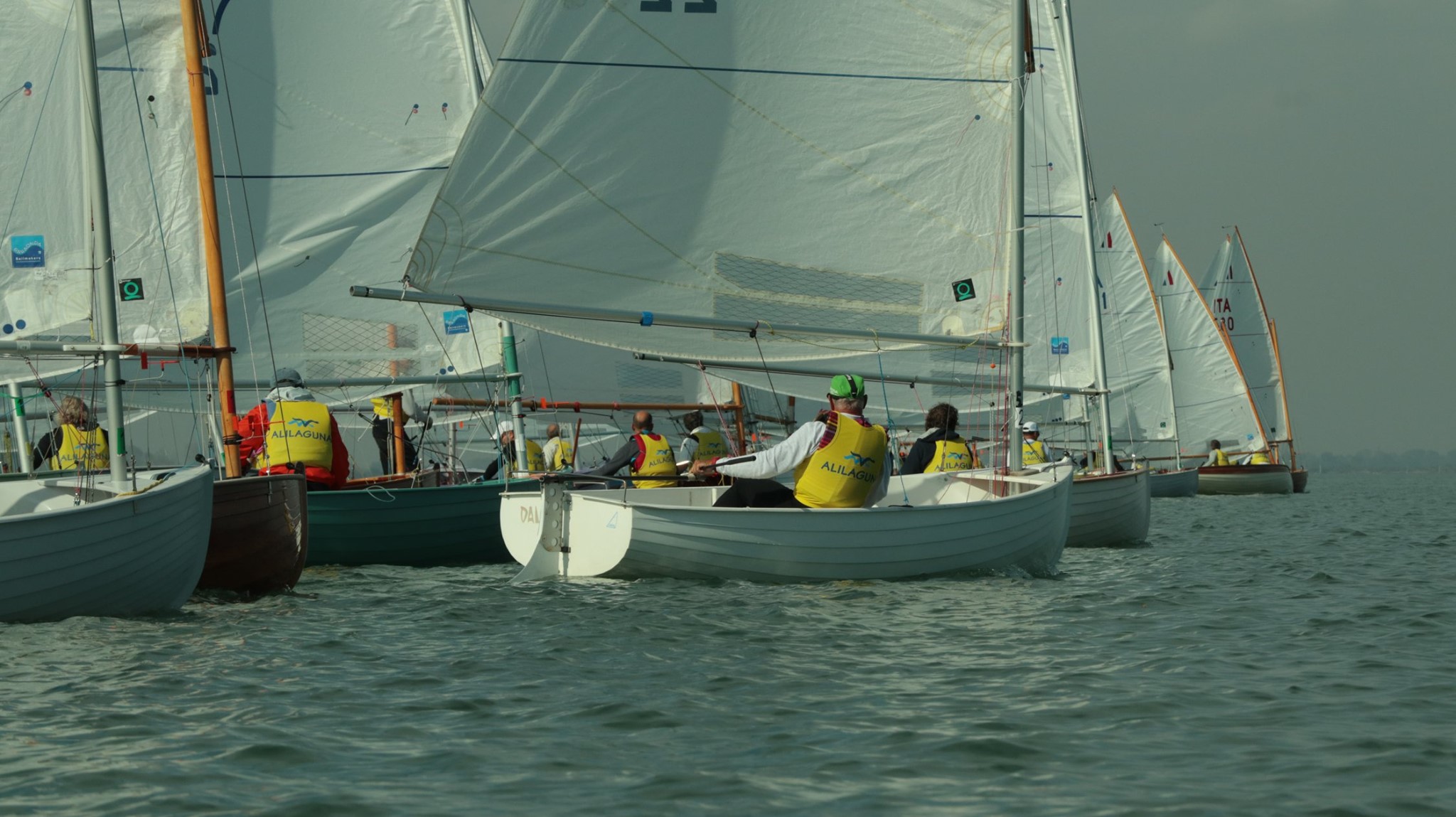 Alcune piccole imbarcazioni a vela durante una regata